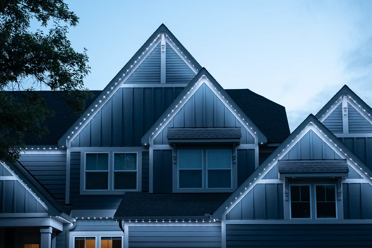Warm-white permanent roofline lighting on a Twin Cities home